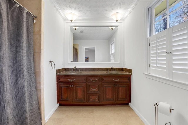 bathroom featuring a shower with curtain, ornamental molding, a textured ceiling, and vanity