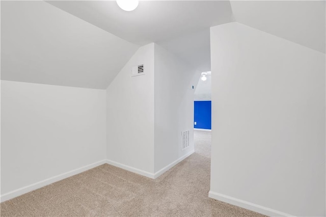 bonus room featuring light colored carpet and vaulted ceiling