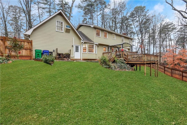 back of property featuring a wooden deck, a yard, and a pergola