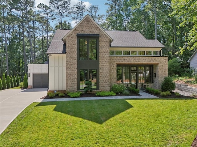 477 Michael Dr, Alpharetta, GA 30009 - view of front facade with a front yard, a garage, brick siding, roof with shingles, and board and batten siding