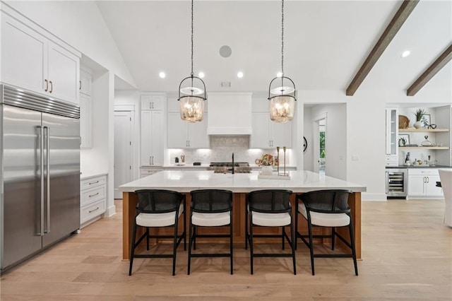 477 Michael Dr, Alpharetta, GA 30009 - kitchen featuring built in refrigerator, beverage cooler, premium range hood, decorative backsplash, and recessed lighting