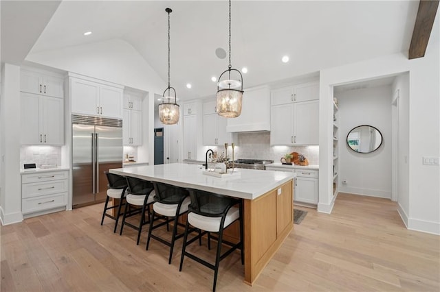 477 Michael Dr, Alpharetta, GA 30009 - kitchen with built in fridge, decorative backsplash, light wood-type flooring, a large island, and recessed lighting