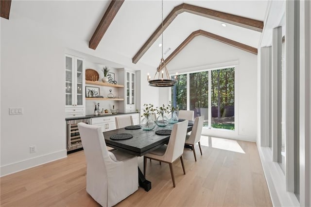 477 Michael Dr, Alpharetta, GA 30009 - dining space with beverage cooler, light wood-style floors, a chandelier, and bar area