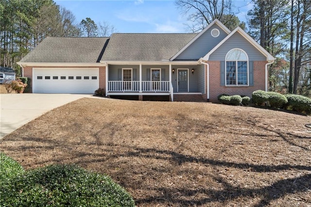 ranch-style home with a porch, a shingled roof, concrete driveway, a garage, and brick siding