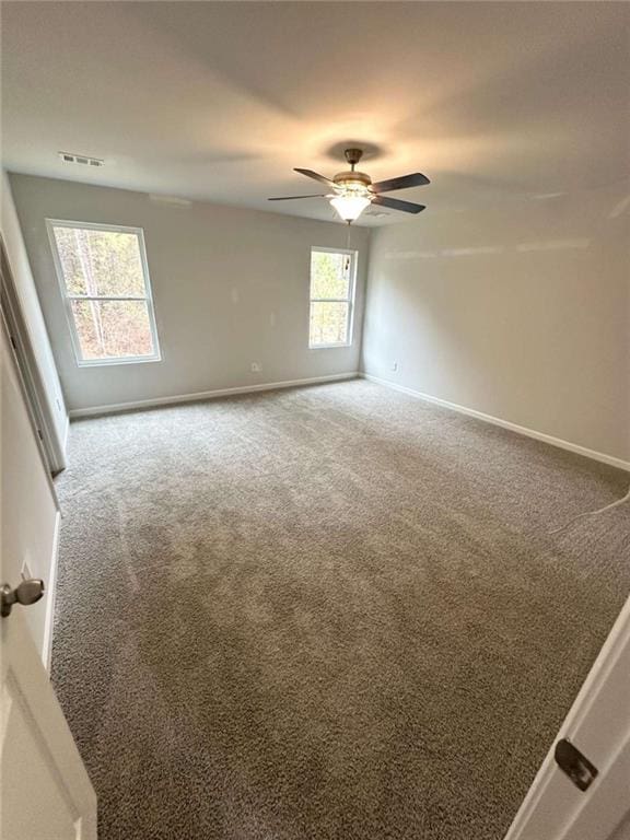 45 Emerald Ln, Covington, GA 30014 - unfurnished room featuring carpet flooring, baseboards, and ceiling fan