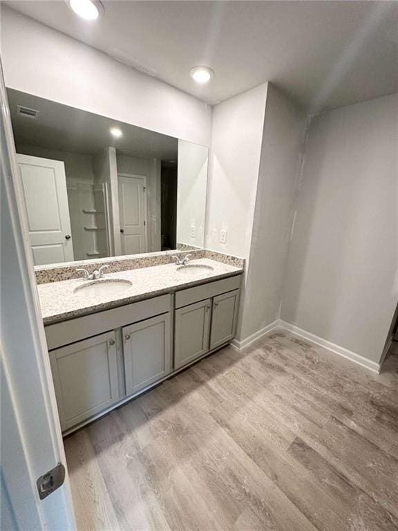 45 Emerald Ln, Covington, GA 30014 - full bath featuring double vanity, wood finished floors, and baseboards