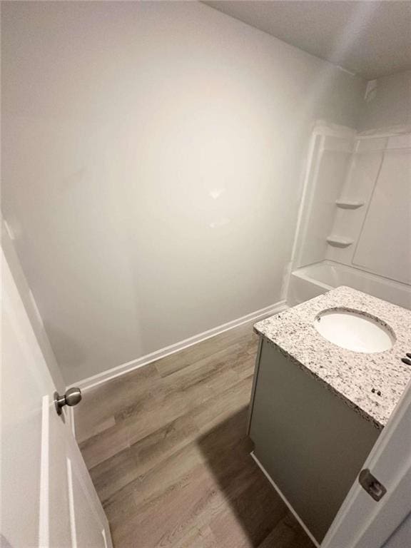 45 Emerald Ln, Covington, GA 30014 - full bathroom featuring vanity, wood finished floors, and baseboards