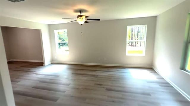 45 Emerald Ln, Covington, GA 30014 - empty room with ceiling fan, wood finished floors, and baseboards
