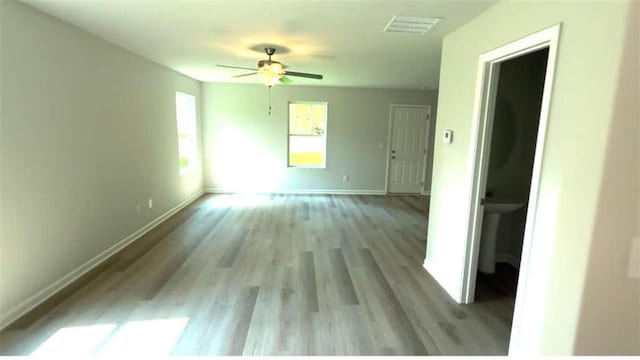 45 Emerald Ln, Covington, GA 30014 - unfurnished room with baseboards, ceiling fan, and light wood-style floors