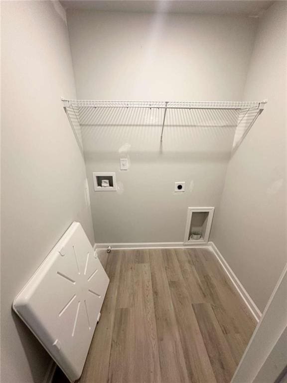45 Emerald Ln, Covington, GA 30014 - washroom featuring hookup for a washing machine, hookup for an electric dryer, wood finished floors, and baseboards