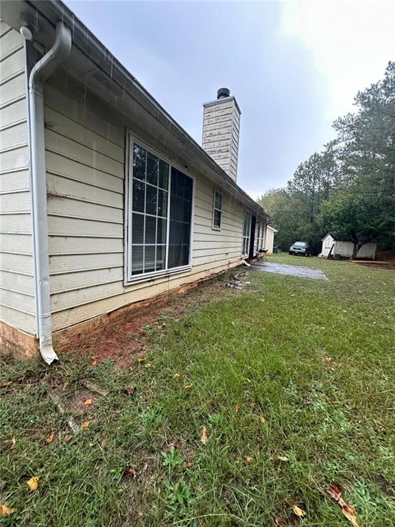 view of side of property with a yard