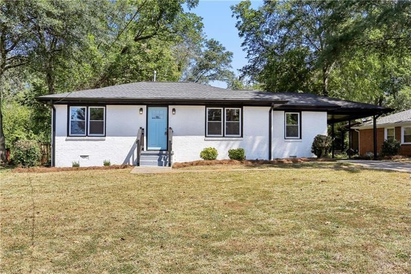 ranch-style home with a front lawn