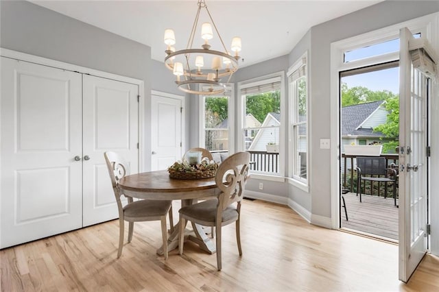 dining room featuring an inviting chandelier, light wood finished floors, baseboards, and visible vents