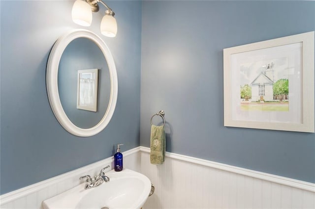 bathroom featuring wainscoting and a sink