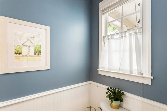 interior space with a wainscoted wall