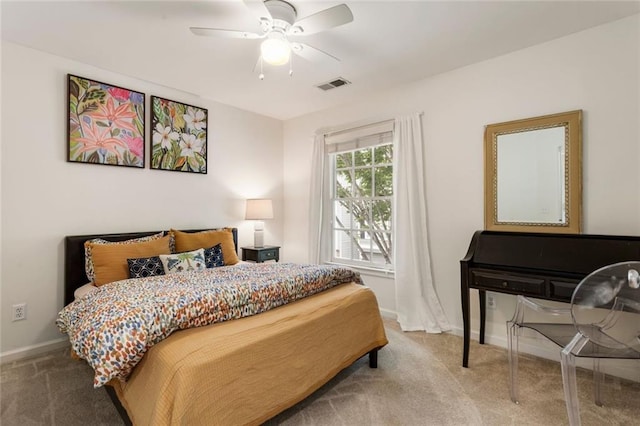 carpeted bedroom with a ceiling fan, baseboards, and visible vents