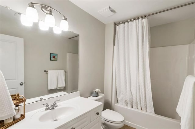full bathroom featuring vanity, shower / bath combo with shower curtain, toilet, and visible vents