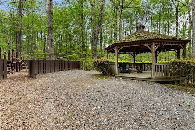 view of yard featuring fence, a wooden deck, and a gazebo