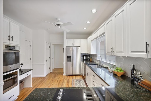 kitchen featuring white cabinetry, appliances with stainless steel finishes, and a sink