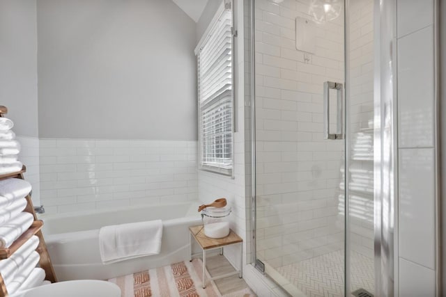 bathroom with a garden tub and a shower stall