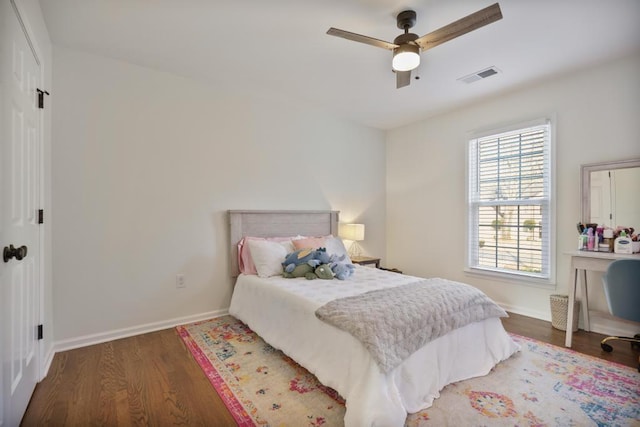 bedroom with visible vents, ceiling fan, baseboards, and wood finished floors