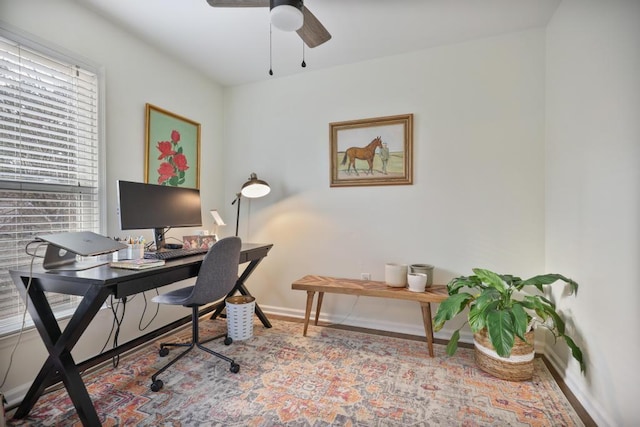 home office featuring baseboards and ceiling fan