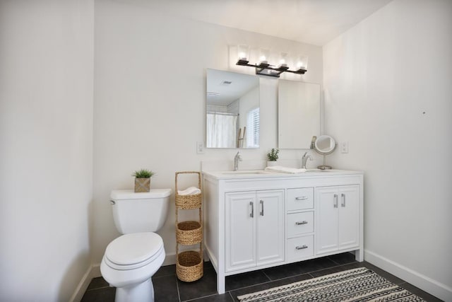 full bathroom featuring a sink, baseboards, toilet, and tile patterned floors