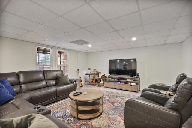 living room featuring a drop ceiling and recessed lighting