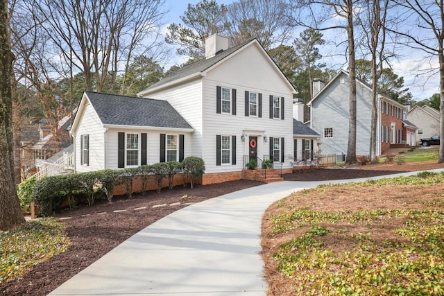 view of front of home featuring a chimney and a shingled roof