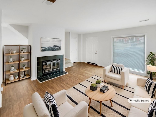 living room with a fireplace and light hardwood / wood-style floors