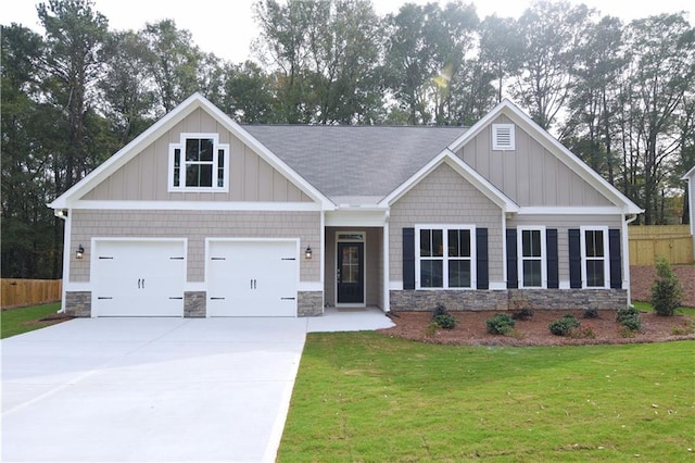 craftsman-style house featuring a front yard and a garage