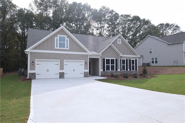 craftsman-style home with central AC, a garage, and a front lawn