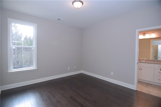 unfurnished room featuring dark hardwood / wood-style floors