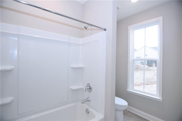 bathroom with toilet and shower / washtub combination