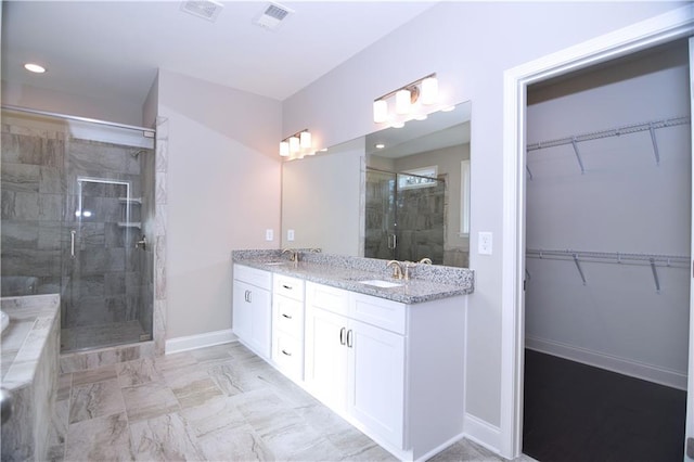 bathroom featuring vanity and an enclosed shower