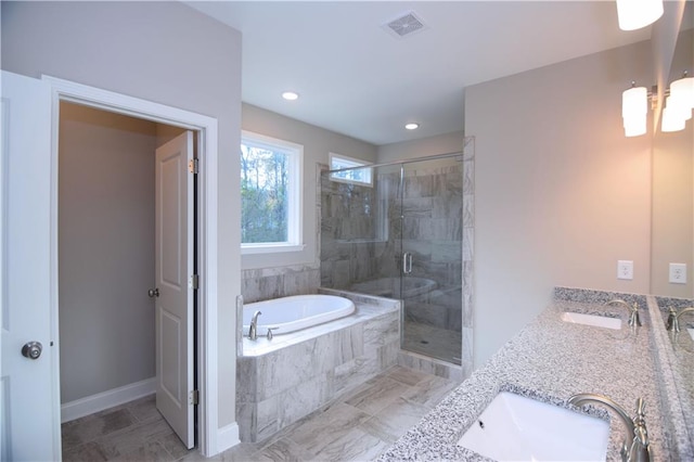 bathroom featuring vanity and shower with separate bathtub