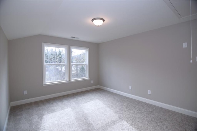 additional living space featuring vaulted ceiling and carpet flooring