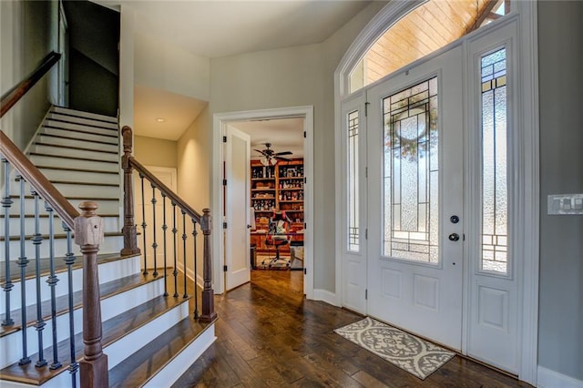 entrance foyer with stairway, baseboards, ceiling fan, and wood-type flooring