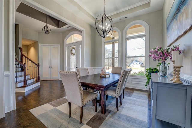 dining room with stairway, visible vents, a tray ceiling, dark wood-type flooring, and a notable chandelier