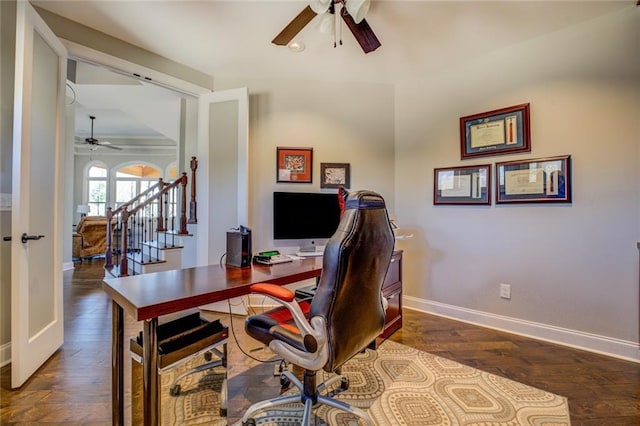 home office featuring dark wood finished floors, a ceiling fan, and baseboards