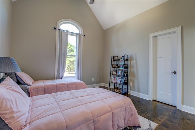 bedroom featuring baseboards and vaulted ceiling