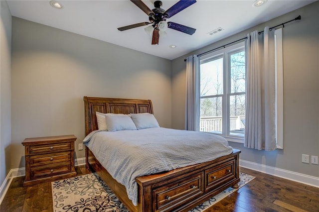 bedroom with dark wood finished floors, visible vents, multiple windows, and baseboards