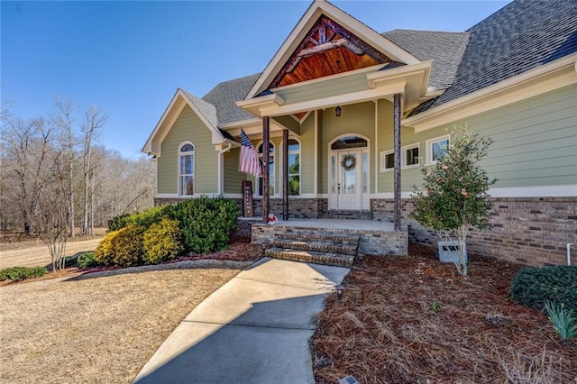 view of front facade featuring a porch and a shingled roof