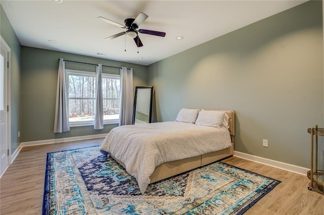 bedroom featuring ceiling fan, baseboards, light wood-style flooring, and recessed lighting