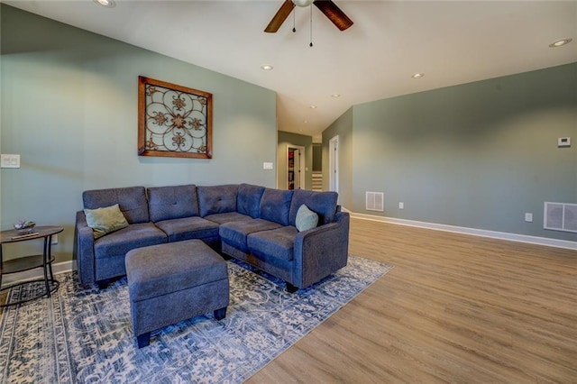 living room featuring visible vents, a ceiling fan, and wood finished floors