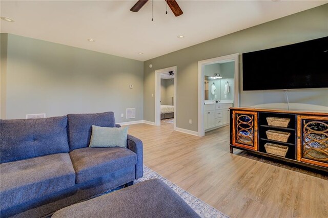 living room with visible vents, baseboards, ceiling fan, light wood-type flooring, and recessed lighting