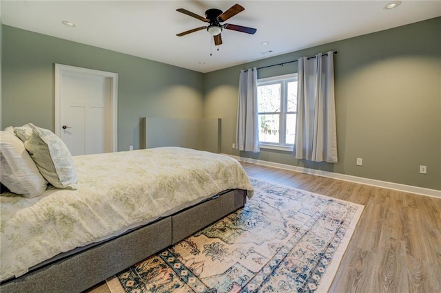 bedroom with recessed lighting, baseboards, wood finished floors, and a ceiling fan