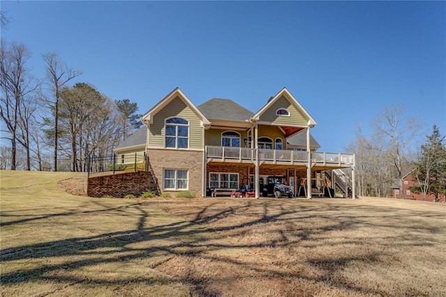 back of house with stairs, a lawn, brick siding, and a wooden deck