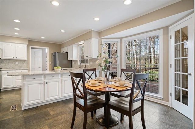 dining room with stone tile floors, visible vents, recessed lighting, and ornamental molding