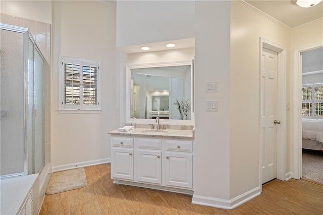 full bathroom featuring a wealth of natural light, a shower stall, baseboards, and connected bathroom